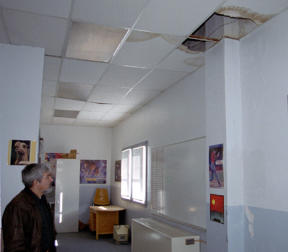 Coupeville School District maintenance director Pope Awe points out holes in the ceiling at the high school.  Estimates to repair the roof could cost $85