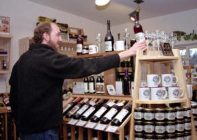 Wine Manager Randy Turner displays one of the 58 varieties of local wine available at the Greenbank Farm Wine Shop.