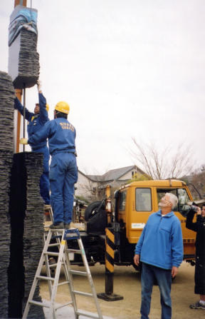 Doug Neil watches his sculpture Pillars of Wisdom being installed in Japan