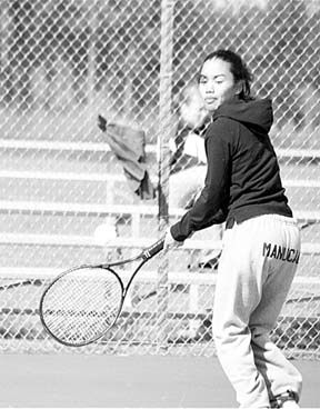 Oak Harbor No. 2 singles player Maggie Manucal warms up against Monroe’s Madie Nelson on Monday. The Wildcat junior knocked off Nelson 6-1