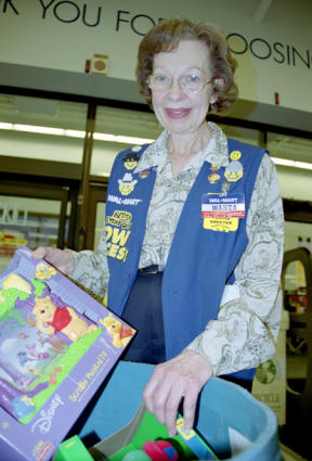 Wal-Mart people greeter Wanda Clayton of Freeland will be more than happy to help people place donated items into the Toys For Tots bin.