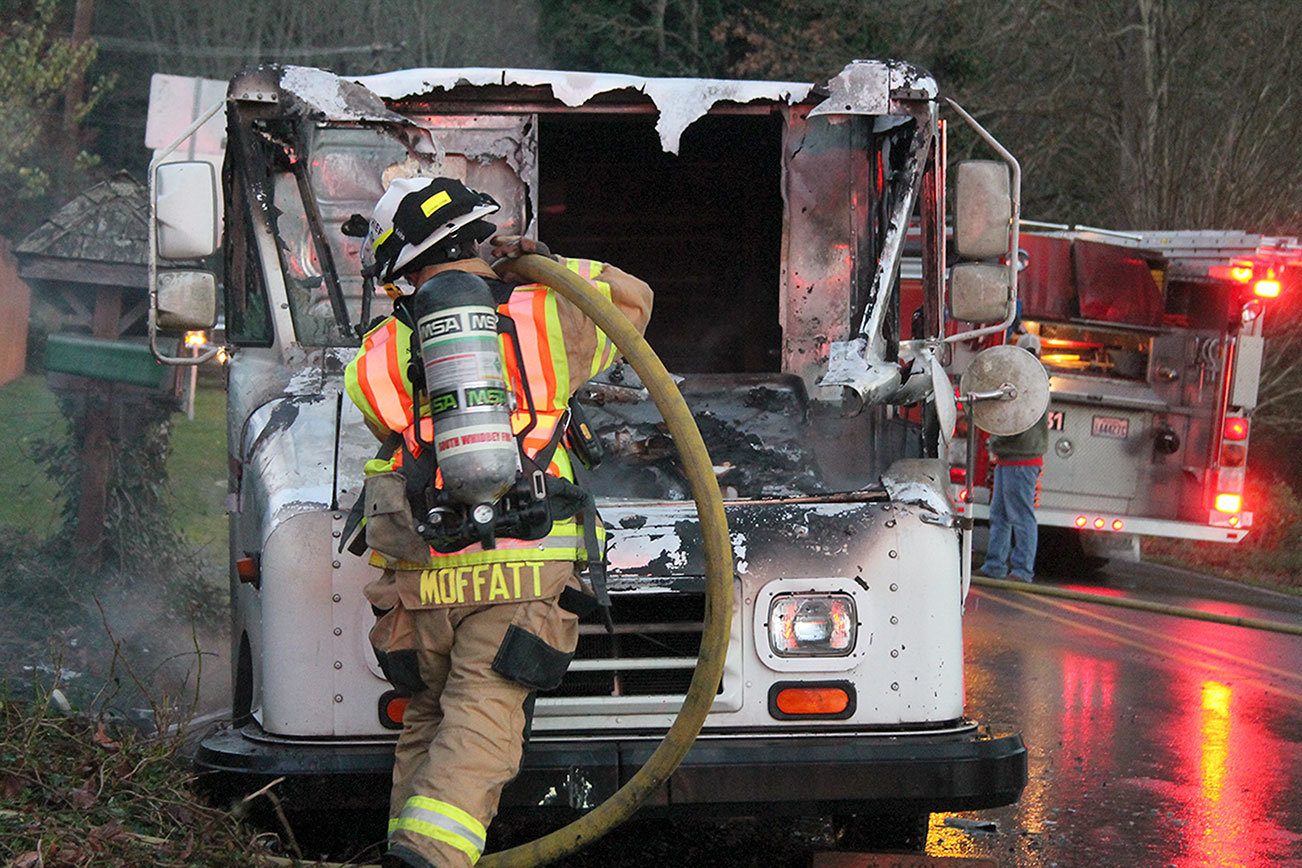 Kyle Jensen / The Record                                South Whidbey Fire/EMS Deputy Chief Wendy Moffatt douses the flames.