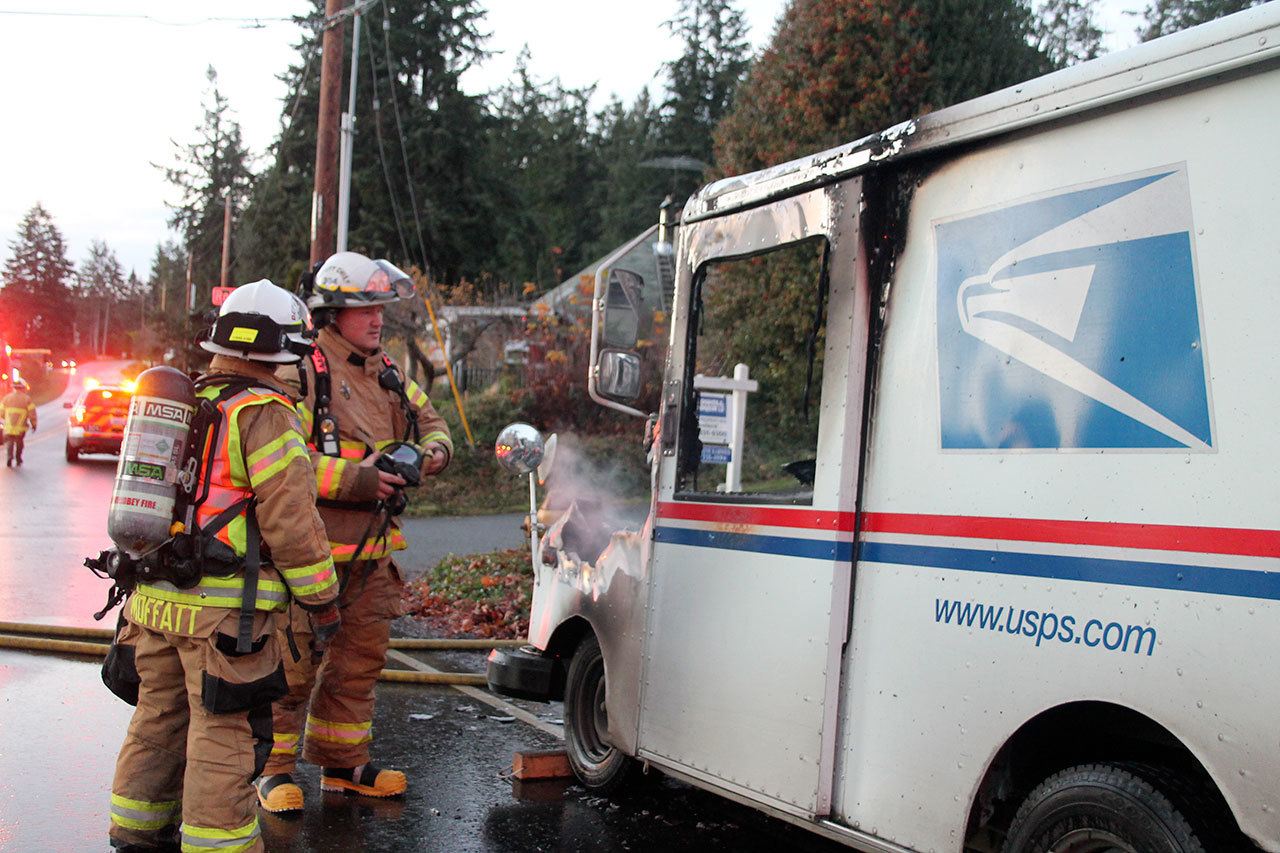Kyle Jensen / The Record                                South Whidbey Fire/EMS Deputy Chiefs Wendy Moffatt and Jon Beck discuss the vehicle fire. The mail truck caught fire while on a regular delivery route.