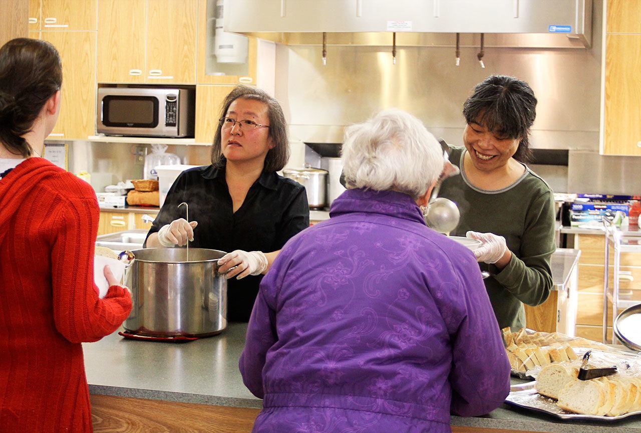Hidemi Dettman and Sachie Sutterluety of Spin Cafe serve up soup at Oak Harbor United Methodist Church before a meeting on how to create an overnight emergency shelter for North Whidbey. About 150 people attended. The new shelter may open as early as Feb. 1.                                Photo by Patricia Guthrie/Whidbey News-Times