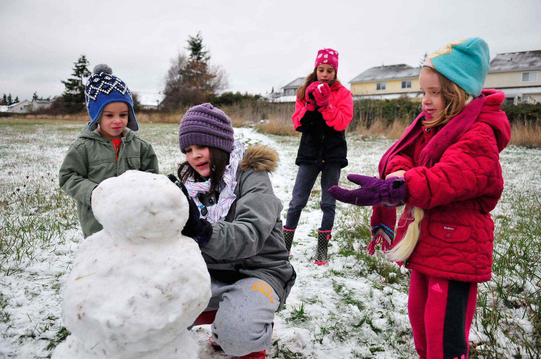 Photo by Michael Watkins/Whidbey News-Times                                Wyatt Waite, Grace Waite, Maggie Waite and Isabel Waite take advantage of the first snow of the season in Oak Harbor Friday. Meteorologists predicted the snow earlier in the week but it finally fell Thursday night into Friday morning. About two inches of snow fell on North Whidbey. Oak Harbor schools started two hours late and personnel at Naval Air Station Whidbey Island were asked to arrive two hours later than normal.