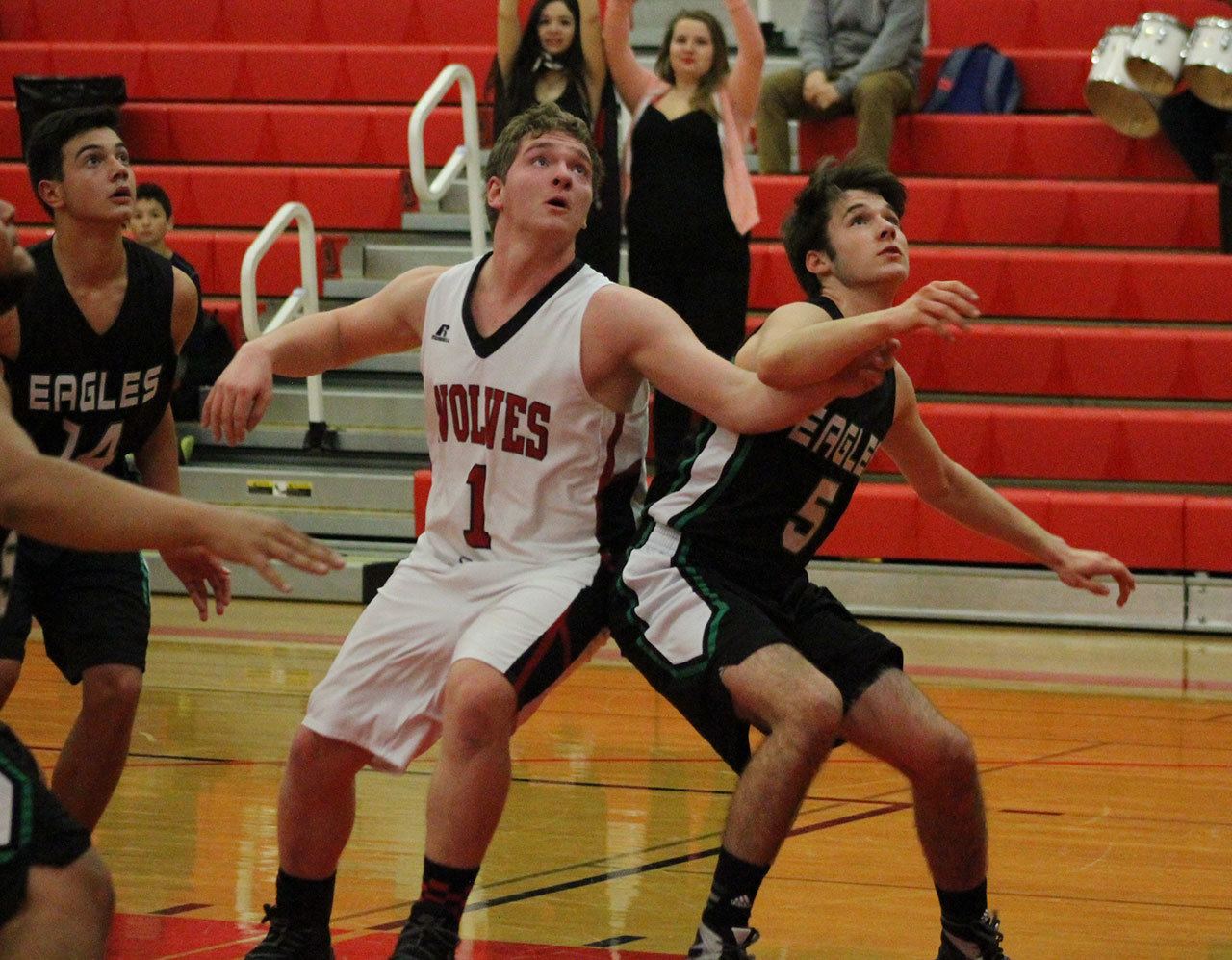 Coupeville’s Gabe Wynn (1) battles for rebounding position on a free throw with Klahowya’s Garett Betzing. (Photo by Jim Waller)