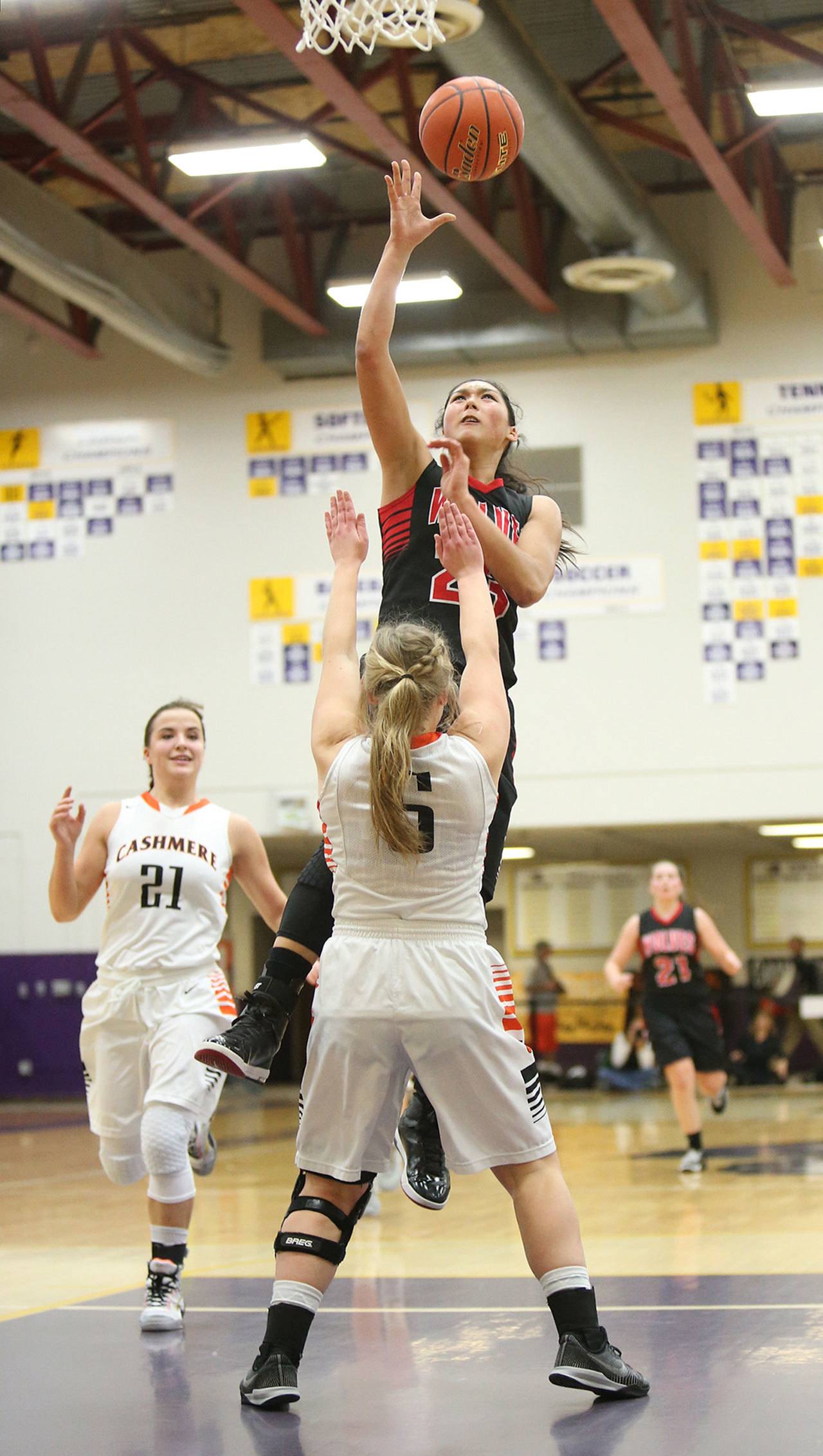 Coupeville’s Makana Stone, shown here scoring in the regional basketball tournament, graduated as one of the most celebrated athletes in school history. (Photo by John Fisken)