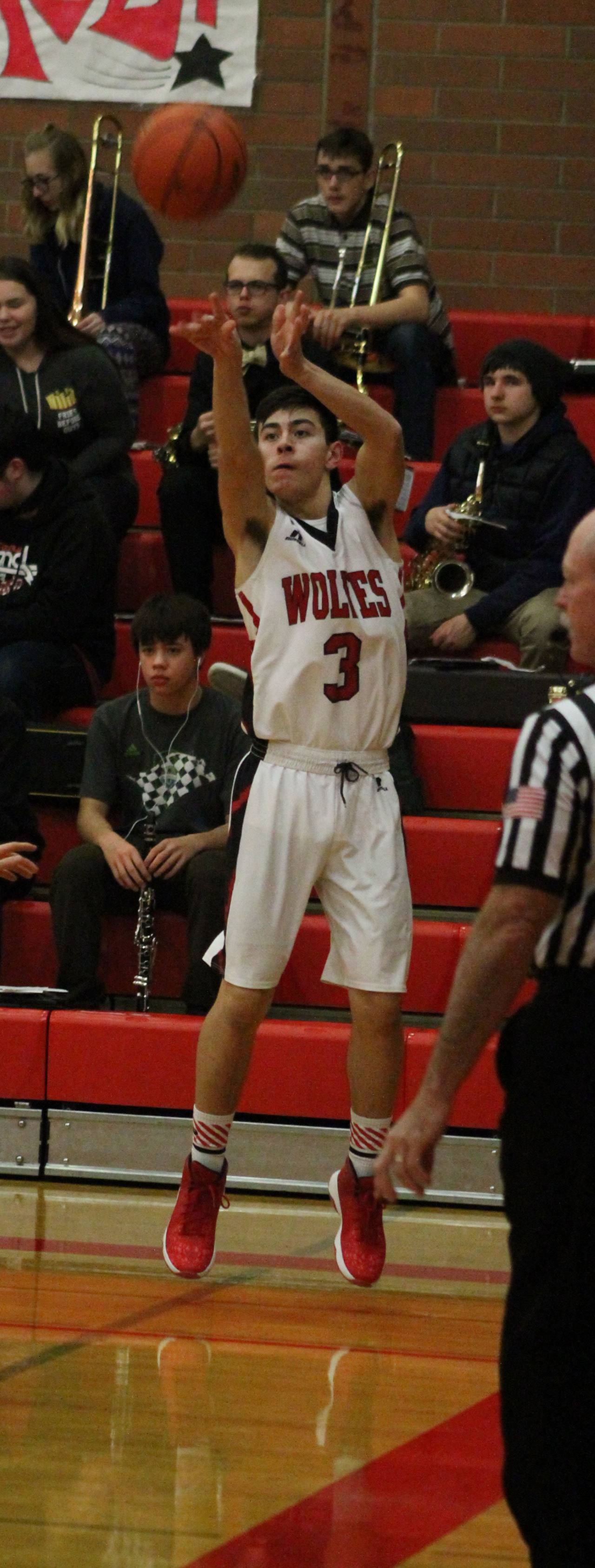 Hunter Smith fires up a shot in the Wolves’ win over Klahowya Dec. 13. His efforts in the game earned him WIAA Athlete of the Week honors. (Photo by Jim Waller)