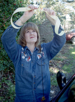 Krista Wisner ties a yellow ribbons on her vehicle’s radio antenna