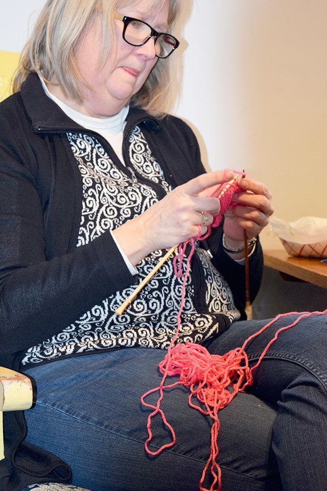 Pam Muncey leads a circle of knitters at Langley&rsquo;s Knitty Purls. Hundreds of hats for the Jan. 21 women&rsquo;s marches in many cities have been made around Whidbey in the past month. Stores often ran out of pink yarn and needles.                                Photo by Patricia Guthrie/Whidbey News-Times