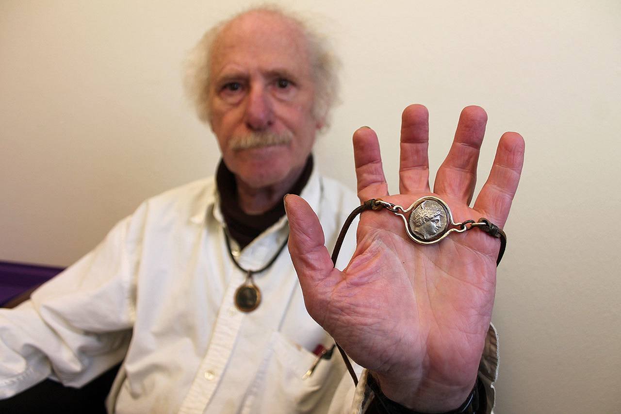 Kyle Jensen / The Record                                Bayview resident Joseph Kleinman holds up one of his many ancient coin pendants. He wears one every day that depicts Adrian from Alexandria, who he admires for the way he changes provinces in the Roman Empire.