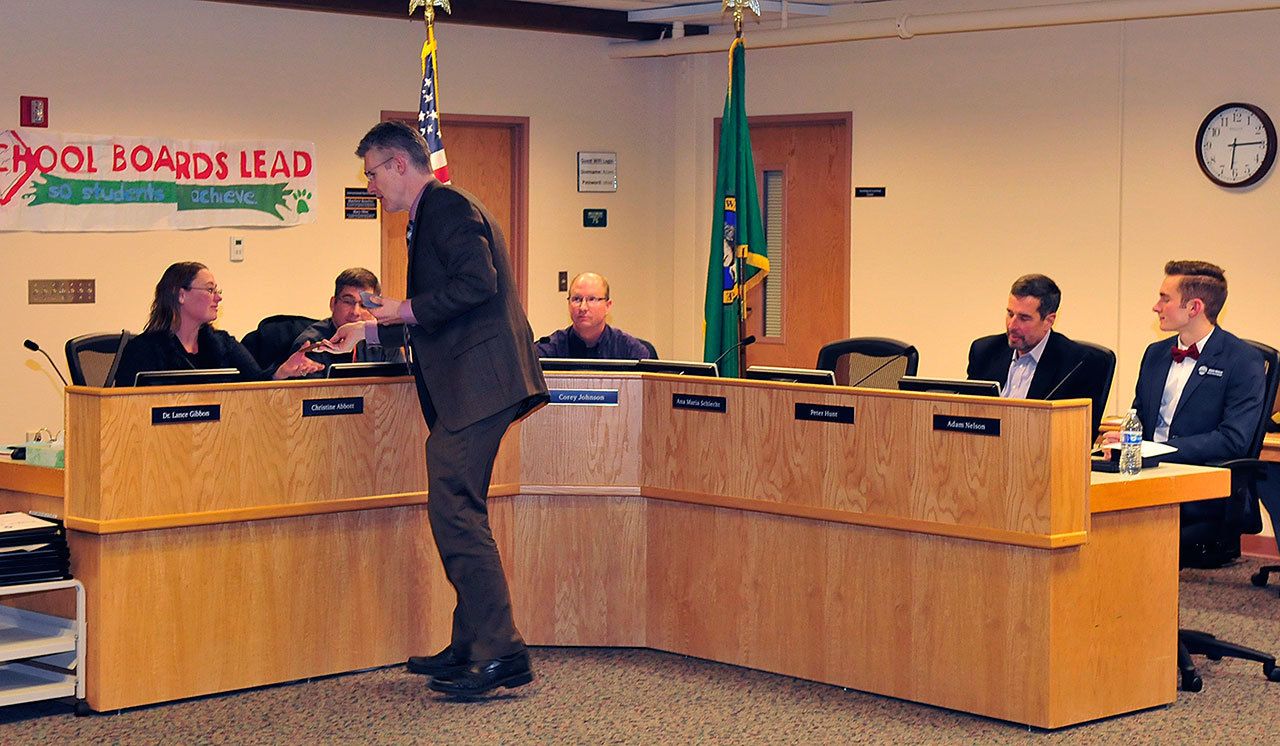 Photo by Michael Watkins/Whidbey News-Times                                Oak Harbor Public Schools Superintendent Lance Gibbon presents letters of appreciation to school board members Monday in Oak Harbor. January is School Board Recognition Month.
