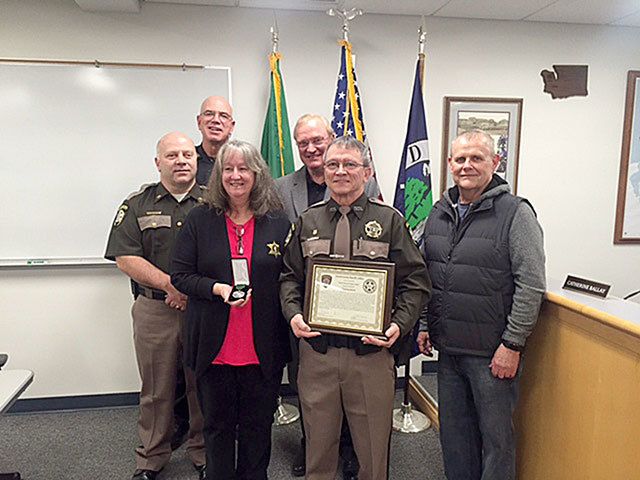 From left: Chief Criminal Deputy Rick Felici, Coupeville Marshall Chris Garden, Lou Ann Miller, Sheriff Mark Brown, Deputy Bo Miller and Larry Vail. Miller recieved a life-saving medal Tuesday for his actions Nov. 3 when Vail had a cardiac incident while on a ladder and fell. Photo provided