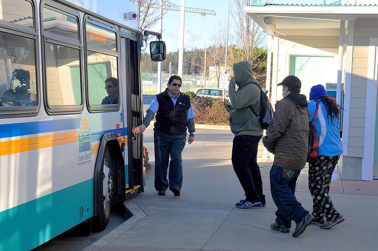 Photo by Michael Watkins/Whidbey News Times                                An Island Transit bus picks up passengers Tuesday in Oak Harbor.