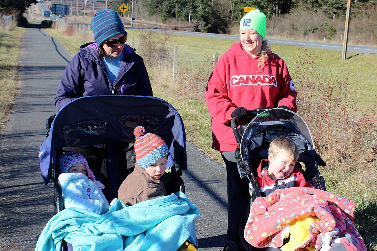 Photo by Patricia Guthrie/Whidbey News-Times                                Kristin Wagner (left) and Kerry Western go for a daily stroll with their children along Coupeville’s Kettles Trail Tuesday. The segment is part of a planned “Bridge to Boat” non-motorized trail along State Road 525 that would run the length of central Whidbey Island.