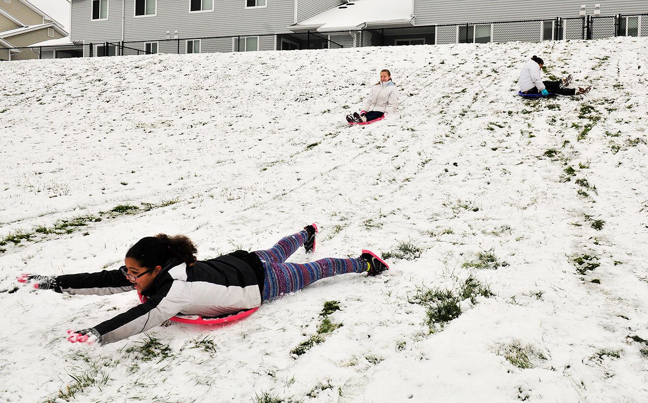 Olivia Gunter, front, sleds with Lauren Piel, left, and Irene Gunter Monday in Oak Harbor. Photo by Michael Watkins/Whidbey News-Times
