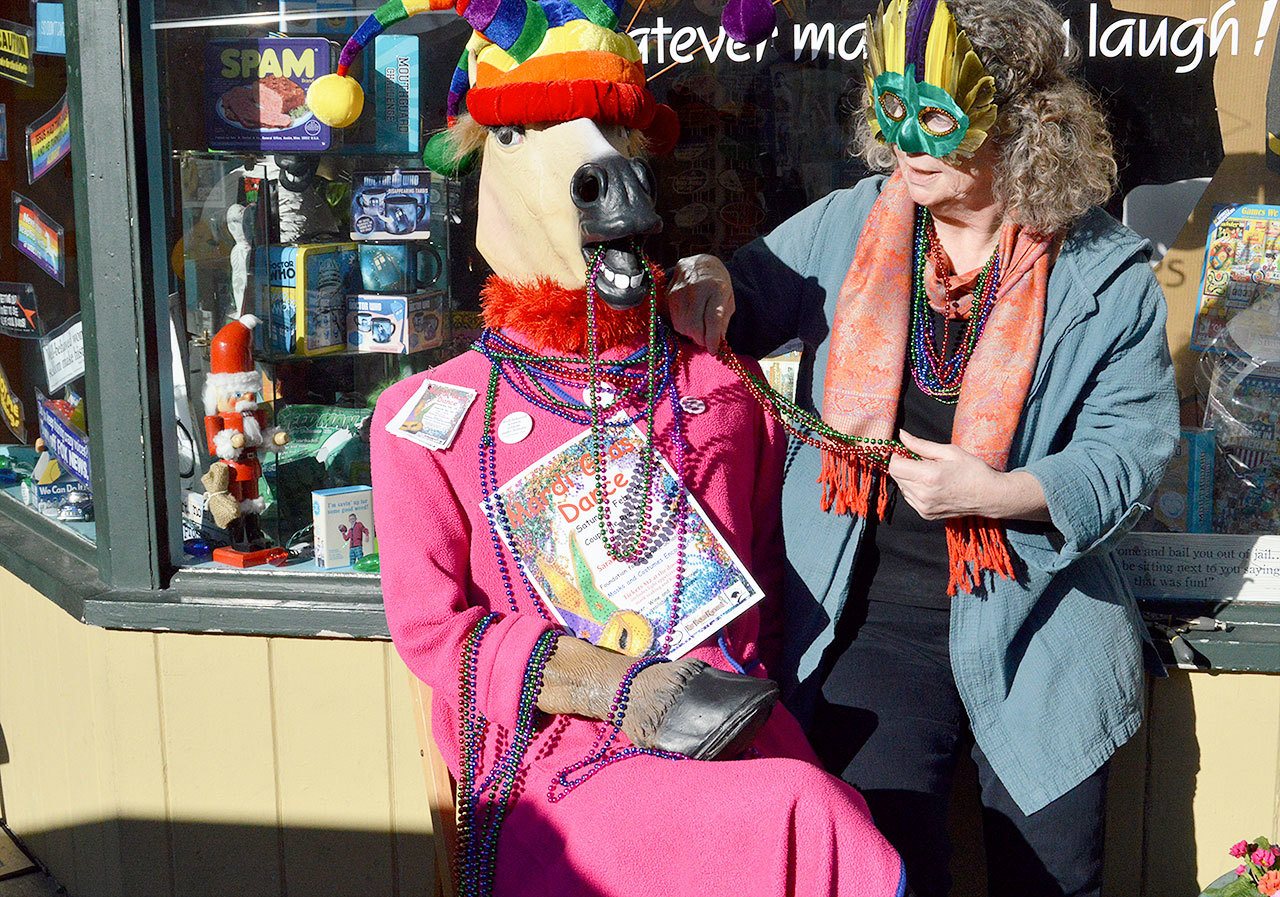 Cindy Van Dyke decorates mascot Pat to advertise the the Mardi Gras Dance on Feb. 25 which will benefit the Community Foundation for Coupeville Public Schools. Photo by Megan Hansen/Whidbey News-Times