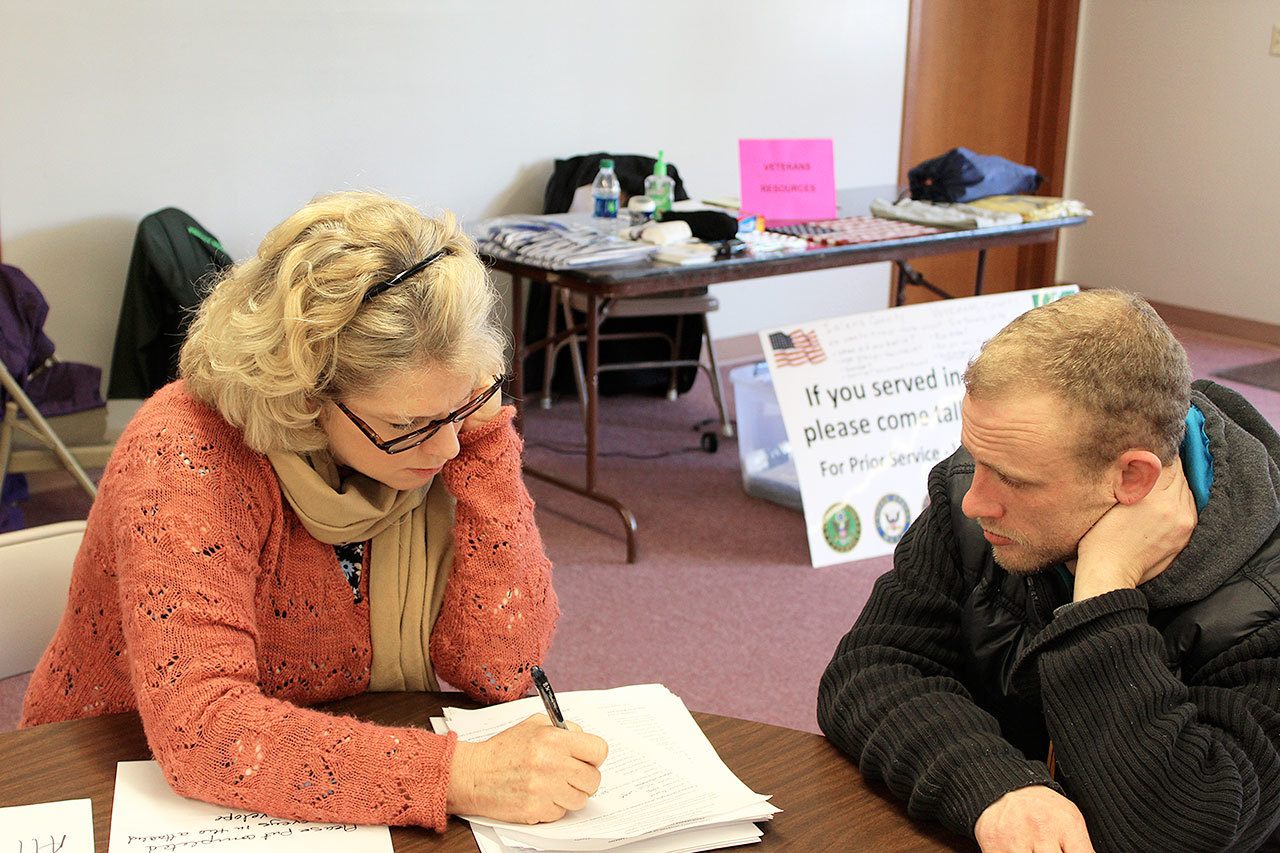 Dana Sawyers, coordinator for Island County Veterans Services, goes through a series of survey questions with Wayne Martin. Collecting more information about area veterans could lead to new assistance programs. Photo by Patricia Guthrie/Whidbey News-Times