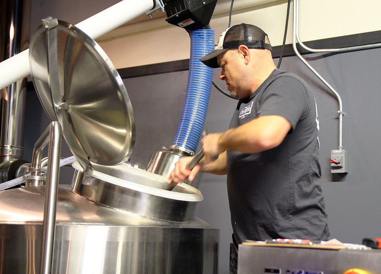 Photo by Jessie Stensland / Whidbey News-Times                                Mitch Aparicio of Penn Cove Brewing stirs a mixture of grain and water during the process of making a new IPA at Bastion Brewing Company in Anacortes Feb. 1.