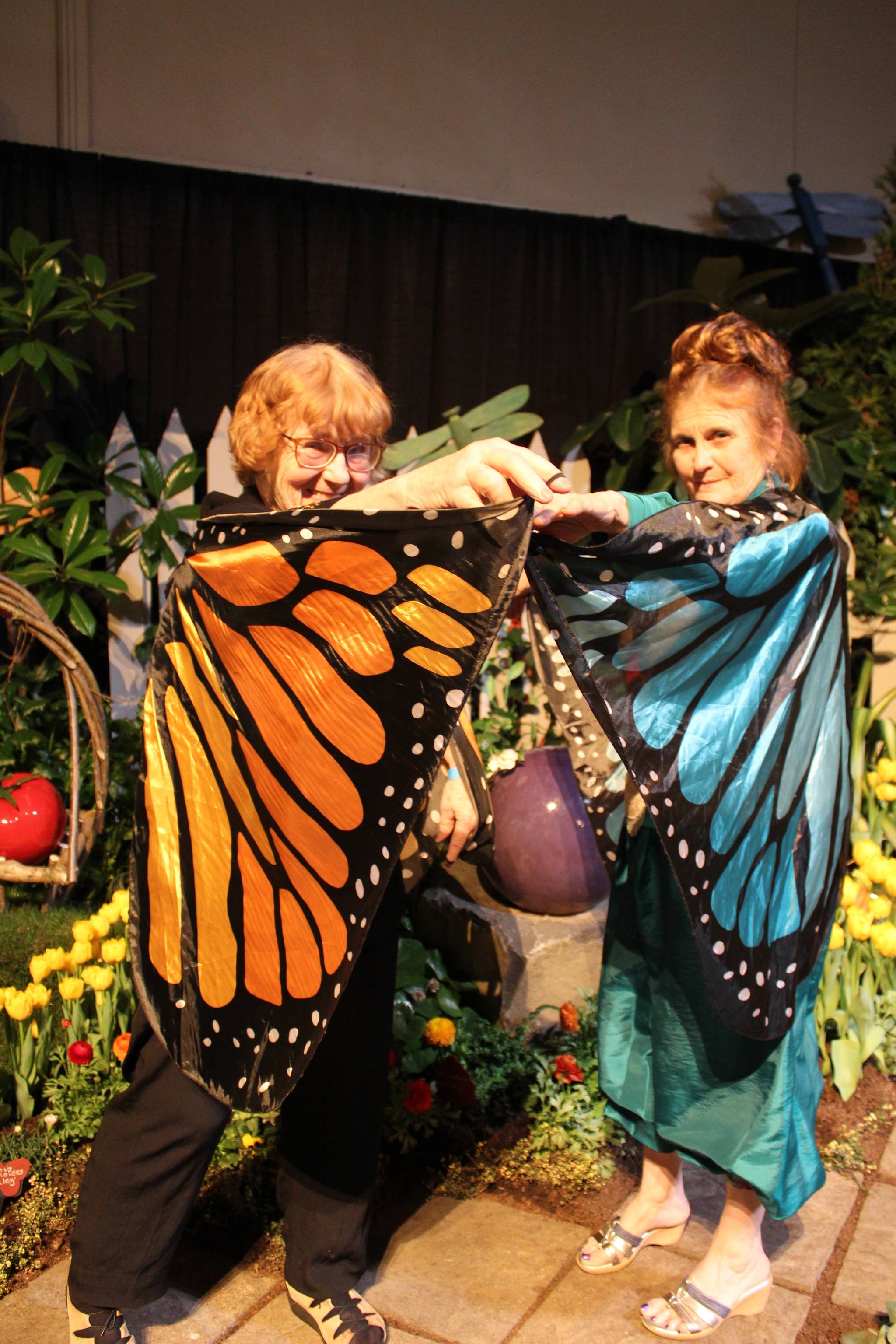 As part of their annual appearance at the Northwest Flower & Garden Show, Vanca Lumsden (left) and Judith Jones always get into character for their displays. This year, they flitted around as butterflies as part of their theme, Bugs Abode: Life Under the Lettuce Leaf. Photo by Patricia Guthrie/Whidbey News-Times