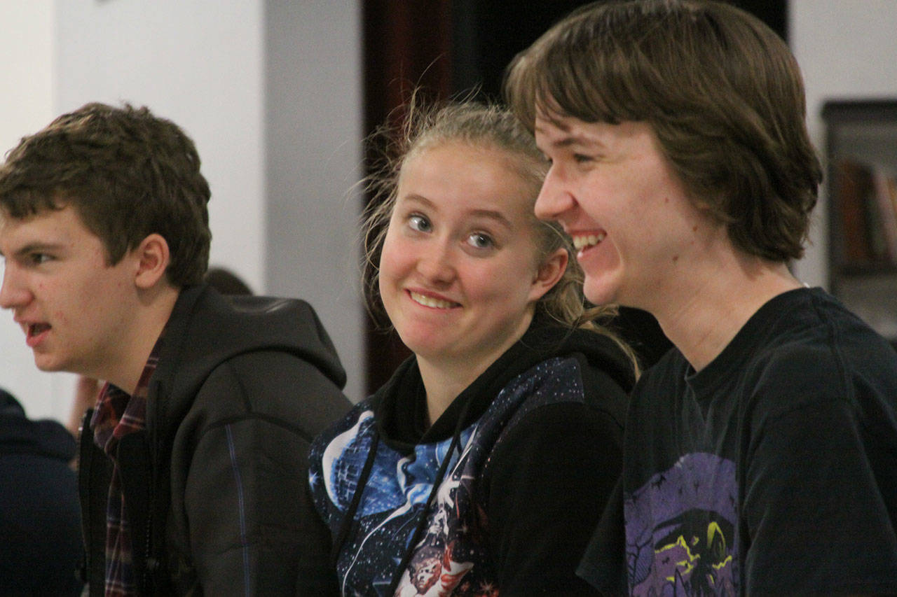 McKenzie Meyer, center, shares a lighter moment with Eric Wertz, right, during Coupeville High School’s Wolf PAC Theatre Troupe rehearsal for “Arsenic and Old Lace” at Coupeville’s Performing Arts Center Monday night, Feb. 27, 2017. Photo by Ron Newberry/Whidbey News-Times