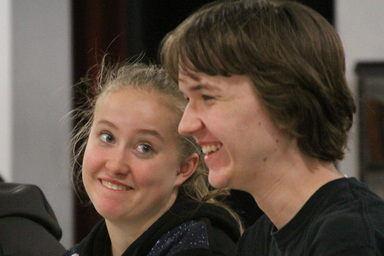 McKenzie Meyer, center, shares a lighter moment with Eric Wertz, right, during Coupeville High School’s Wolf PAC Theatre Troupe rehearsal for “Arsenic and Old Lace” at Coupeville’s Performing Arts Center Monday night, Feb. 27, 2017. Photo by Ron Newberry/Whidbey News-Times