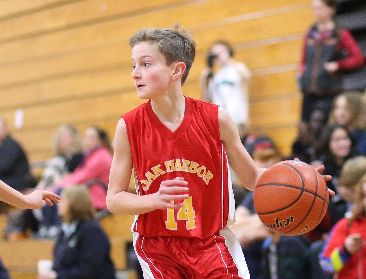 Oak Harbor seventh-grader Will Rankin looks over the defense. Rankin had 6 points, 5 rebounds, 2 blocks and 7 steals in the game. (Photo by John Fisken)