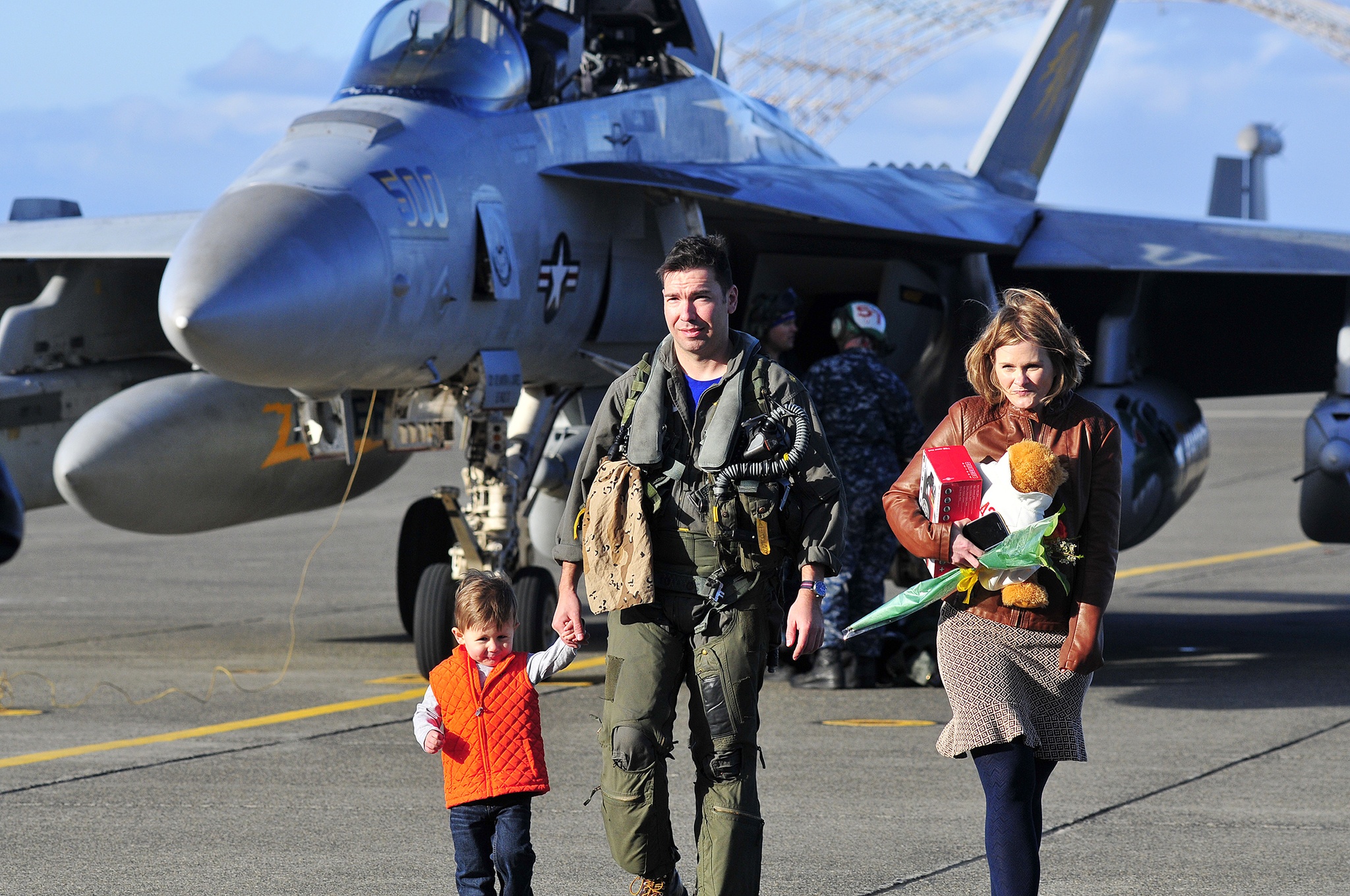 Lt. Cmdr. Kevin Jones assigned to Tactical Electronic Warfare Squadron 130 is greeted by his family upon returning home to Naval Air Station Whidbey Island, Wash. Dec. 30, 2016. Photo by Michael Watkins/Whidbey News-Times
