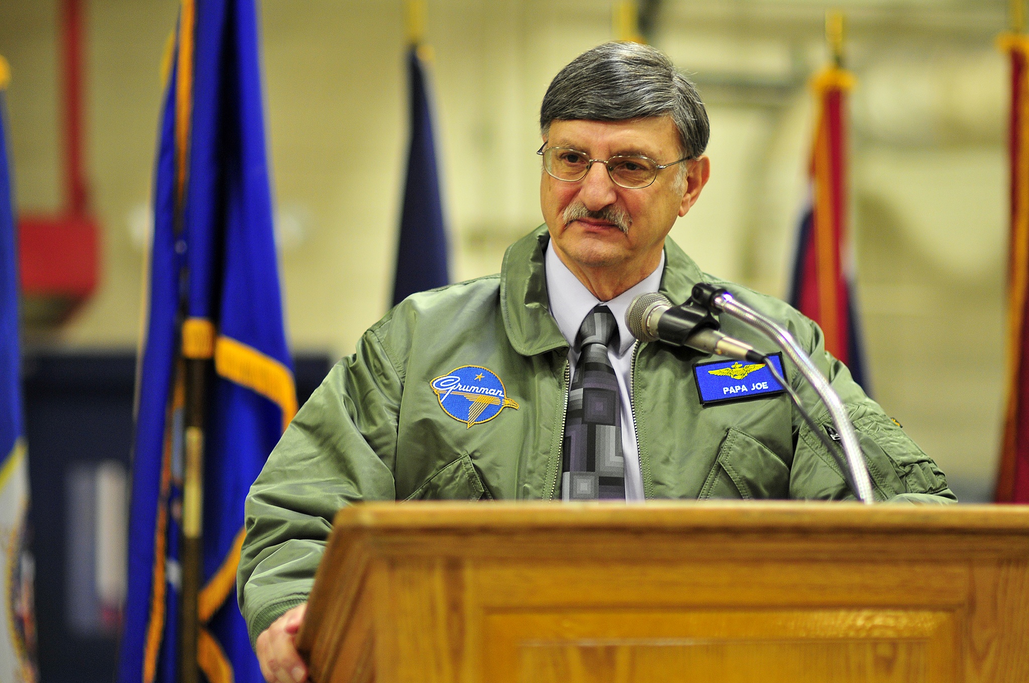 Joe Farina makes his remarks after receiving his new flight jacket and designation as the 29th Honorary Naval Aviator during his surprise retirement parry Jan 13, at NAS Whidbey Island.                                Joe Farina makes his remarks after receiving his new flight jacket and designation as the 29th Honorary Naval Aviator during his surprise retirement parry Jan 13, at NAS Whidbey Island.