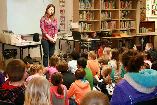 Oak Harbor High School graduate and published author Sandra Evans fields questions from a group of third and fourth graders at Crescent Harbor Elementary Friday. Photo by Daniel Warn/Whidbey News-Times.