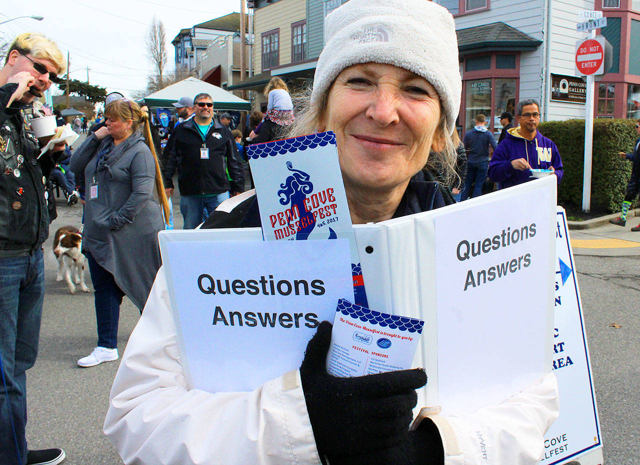 Volunteer Lynn Hyde was a walking information booth Saturday, answering any questions visitors may have.                                Photo by Patricia Guthrie/Whidbey News-Times