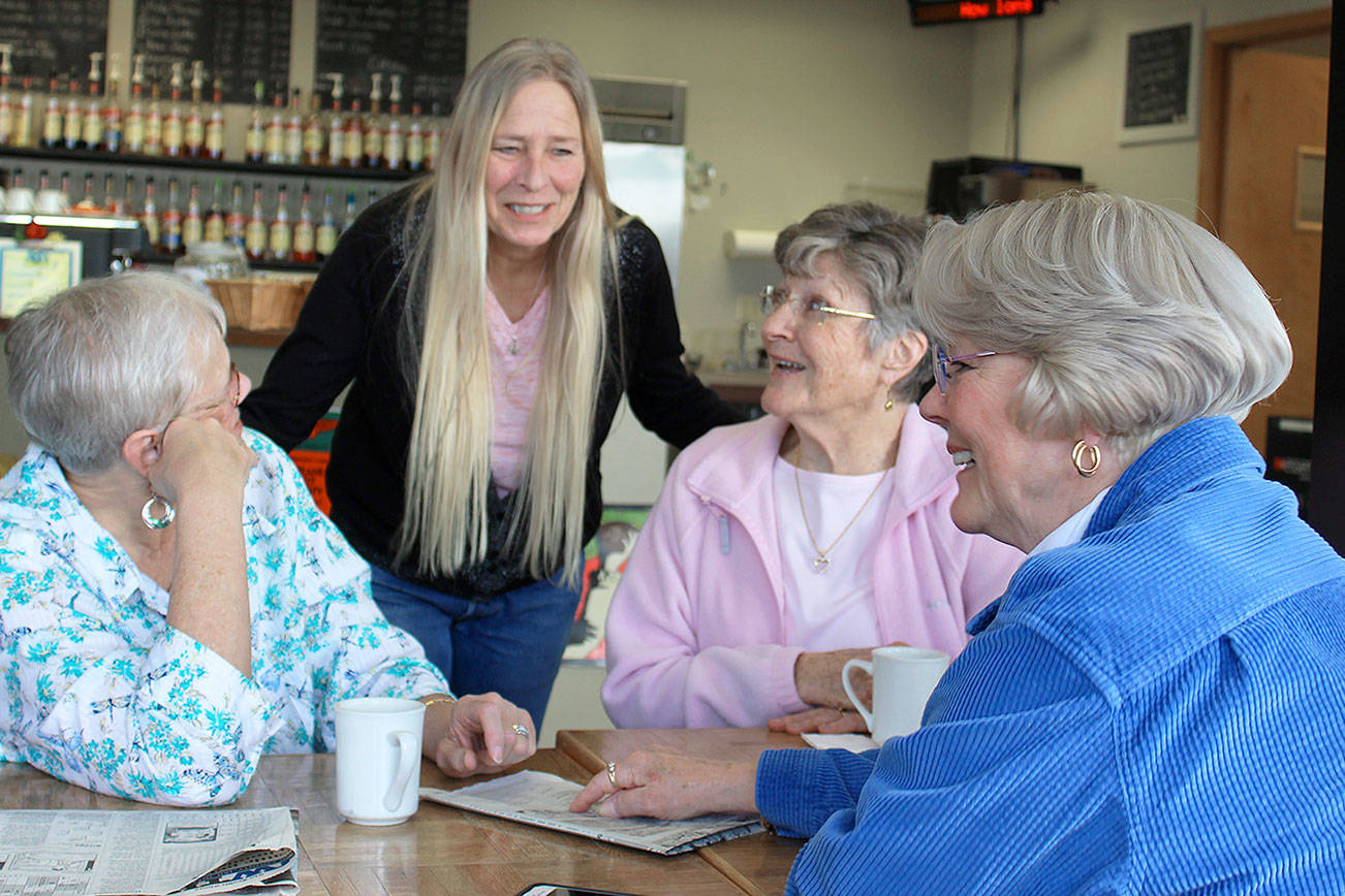 Photo by Patricia Guthrie/Whidbey News-Times                                Daily Grind owner Tammie DeRosa greets some regular customers, one of many senior groups that gather daily at the Oak Harbor downtown shop that’s closing March 31.