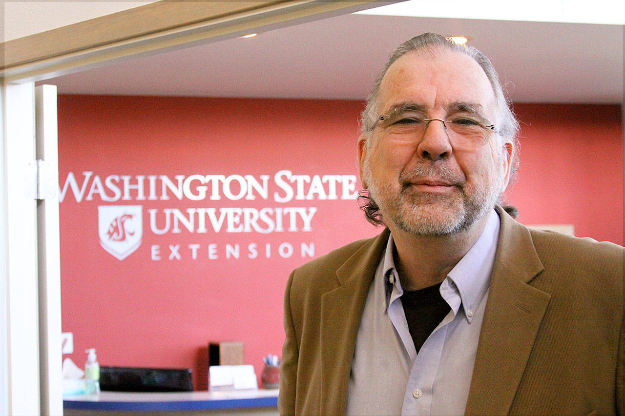 Dr. Tim Lawrence, director of Washington State University’s Island County Extension in Coupeville, explains how a conference room will be used for WSU classes using video-conferencing equipment. Photo by Ron Newberry/Whidbey News-Times