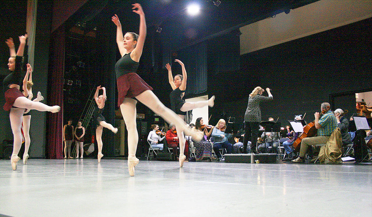 Anna Edwards, right, conducts Saratoga Orchestra as dancers from Whidbey Island Dance Theatre rehearse for their upcoming collaboration, “All About the Dance.” Photo by Daniel Warn/Whidbey News-Times