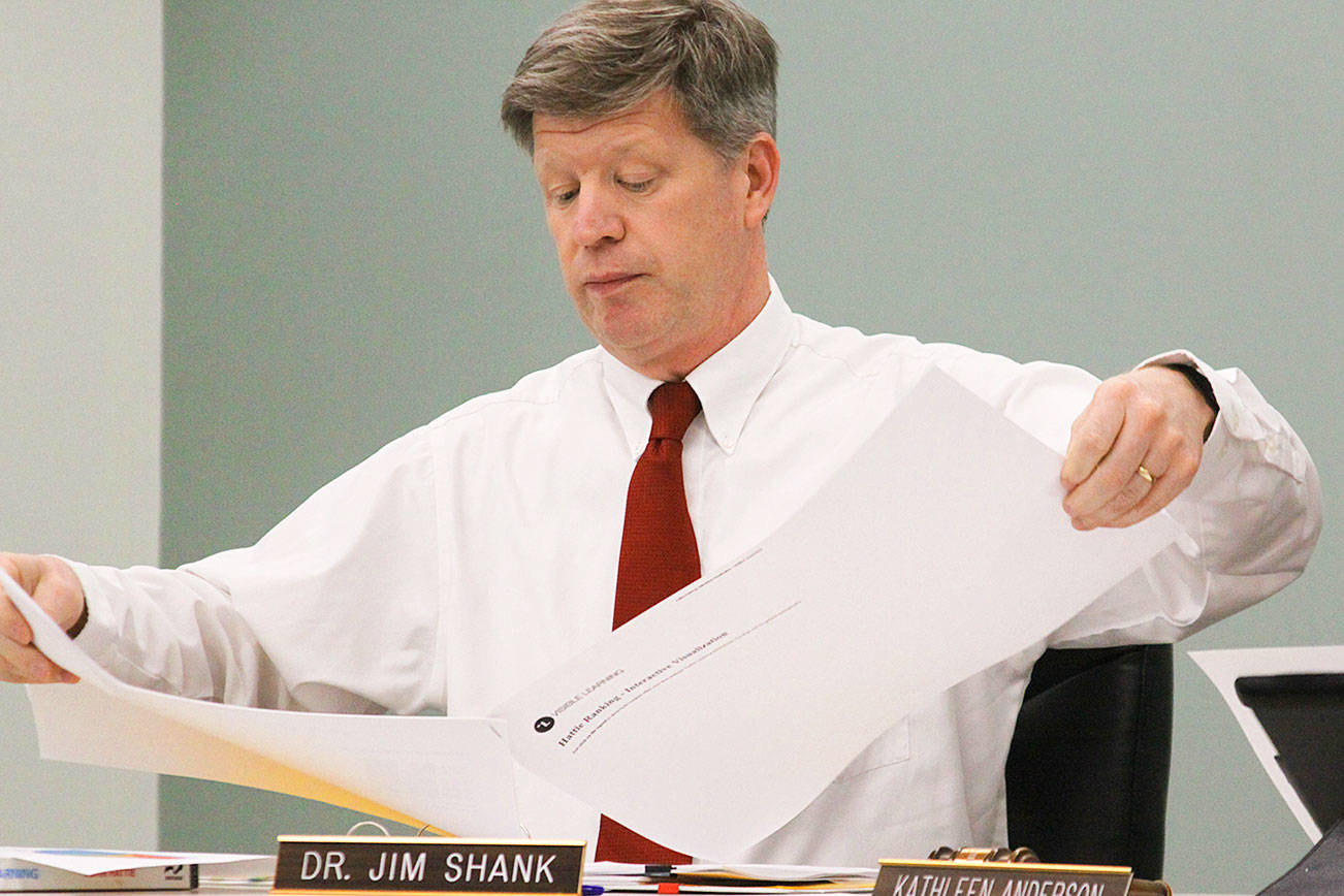 Coupeville School District Superintendent Jim Shank looks over plans at a school board meeting. Shank is a finalist for the superintendent post in Twin Falls, Idaho. Photo by Ron Newberry