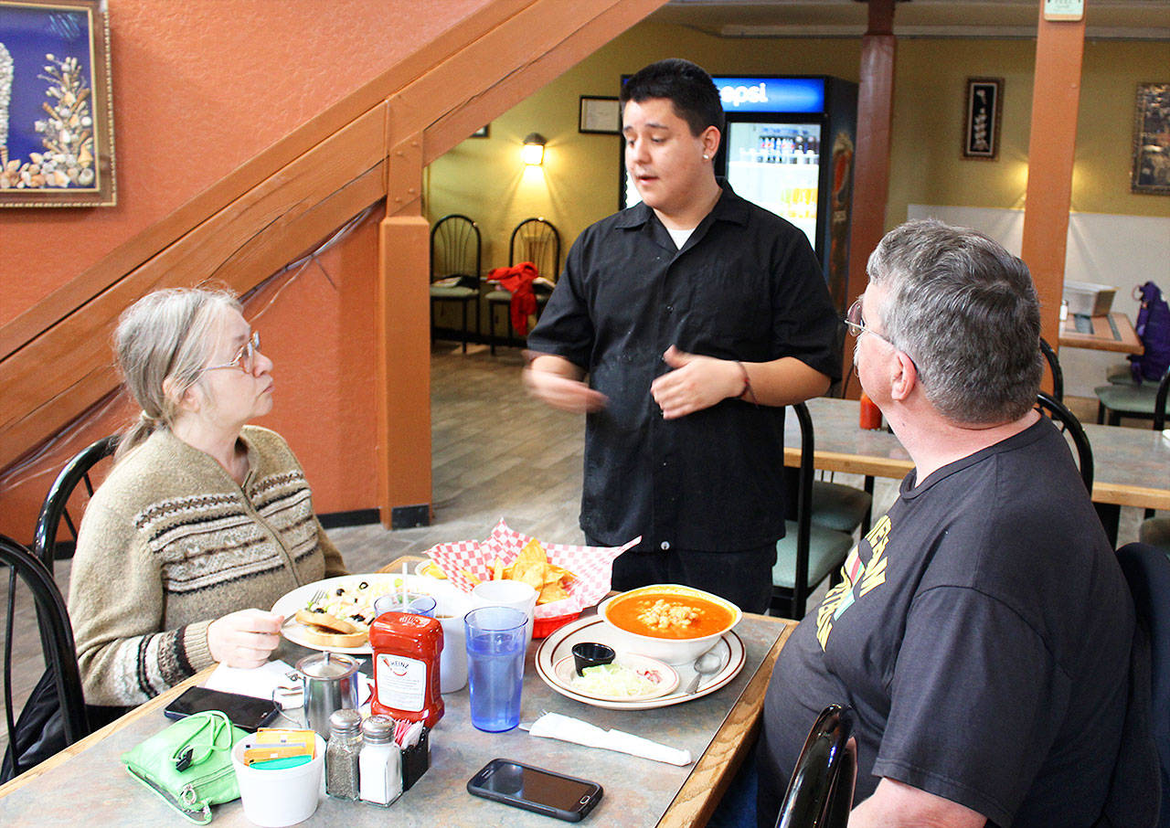 Jose Ochoa chats with customers Bridget and Lyle Zimmerman at Noe Jose Cafe Family Restaurant that opened two weeks ago in downtown Oak Harbor. Jose and his brother, Noe, decided to open the cafe after years of working at other local restaurants. Photo by Patricia Guthrie/Whidbey News-Times