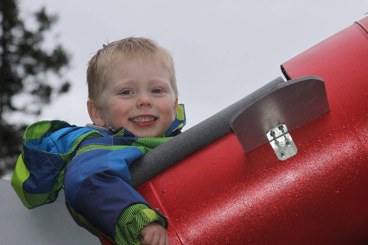 Wyatt Brazelton, 3, is all smiles as he prepares to go on a ride around the roller coaster that his father built for him in their Oak Harbor backyard Wednesday, March 1, 2017. Photo by Ron Newberry/Whidbey News-Times