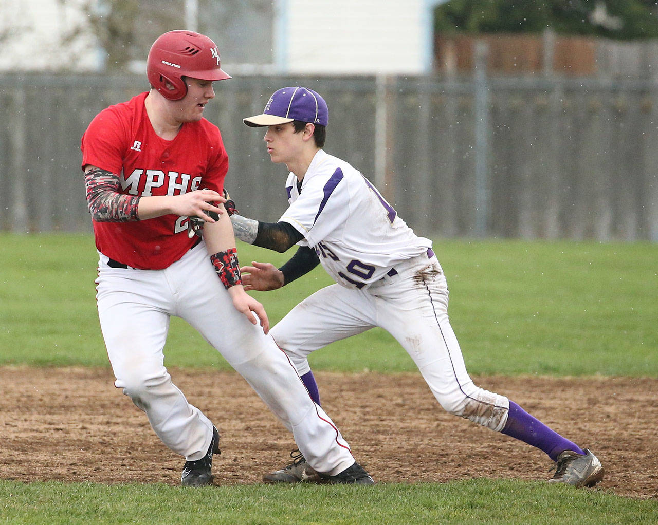 Cory Roberts tags M-P’s Colby Phelps in a rundown Wednesday. (Photo by John Fisken)