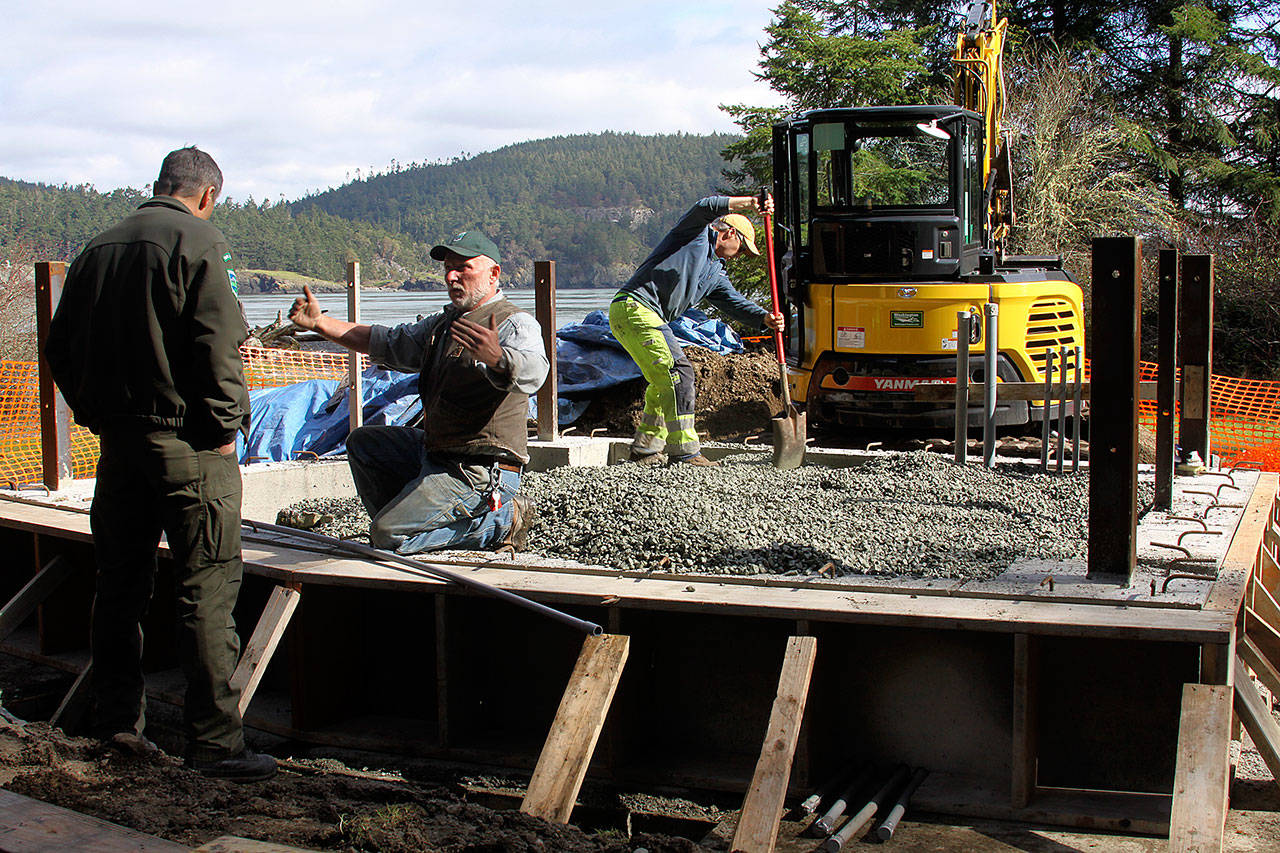 Staff from Deception Pass State Park works on an amphitheater stage project Thursday. They’re building the foundation for the stage that will serve visitors who come to watch entertainment at the amphitheater this summer. Park manager Jack Hartt, left, listens to details from a staff member. Photo by Ron Newberry/Whidbey News-Times