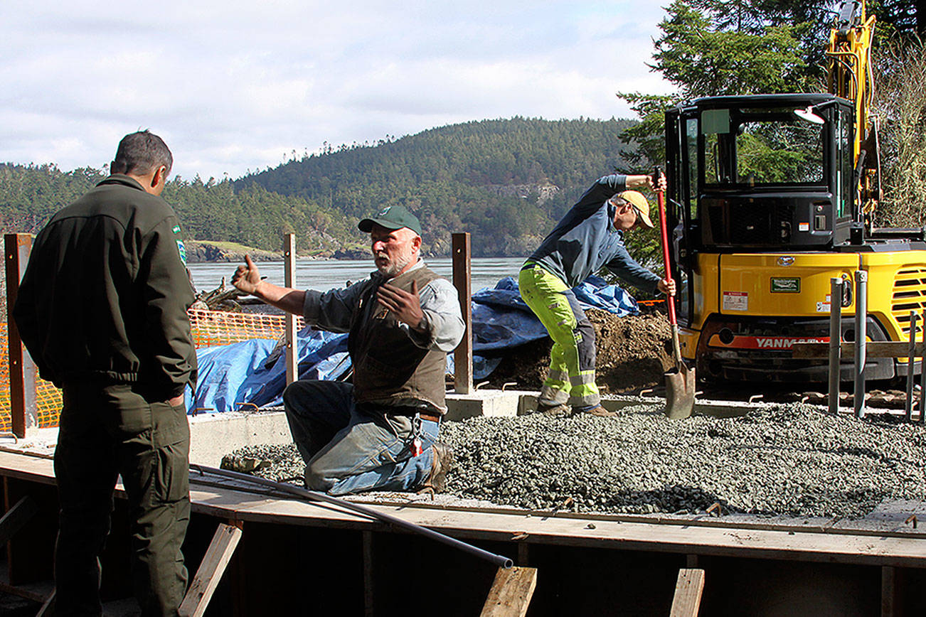Staff from Deception Pass State Park works on an amphitheater stage project Thursday. They’re building the foundation for the stage that will serve visitors who come to watch entertainment at the amphitheater this summer. Park manager Jack Hartt, left, listens to details from a staff member. Photo by Ron Newberry/Whidbey News-Times