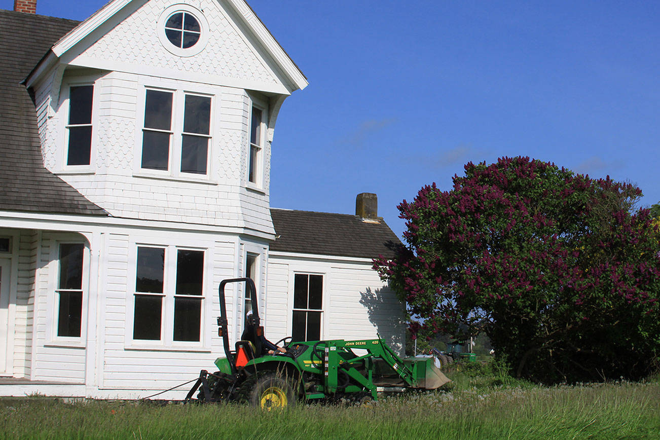 A tractor mows near the Rockwell House in Coupeville in May, 2014. Photo by Ron Newberry/Whidbey News-Times