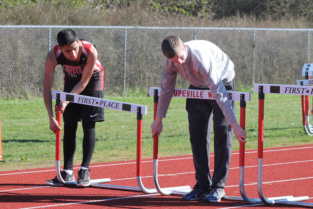 The hurdle crew gets the track ready for the next race. (Photo by Jim Waller/Whidbey News-Times)