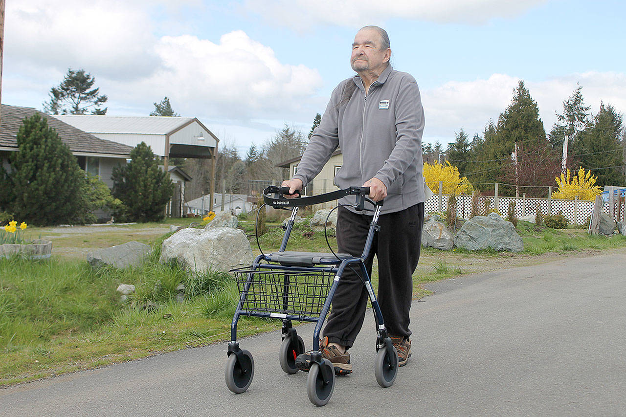 Evan Thompson / The Record — Art Durand, a Coupeville resident and Navy veteran, walks down the street with a Dolomite walker provided to him by the Veteran’s Administration.