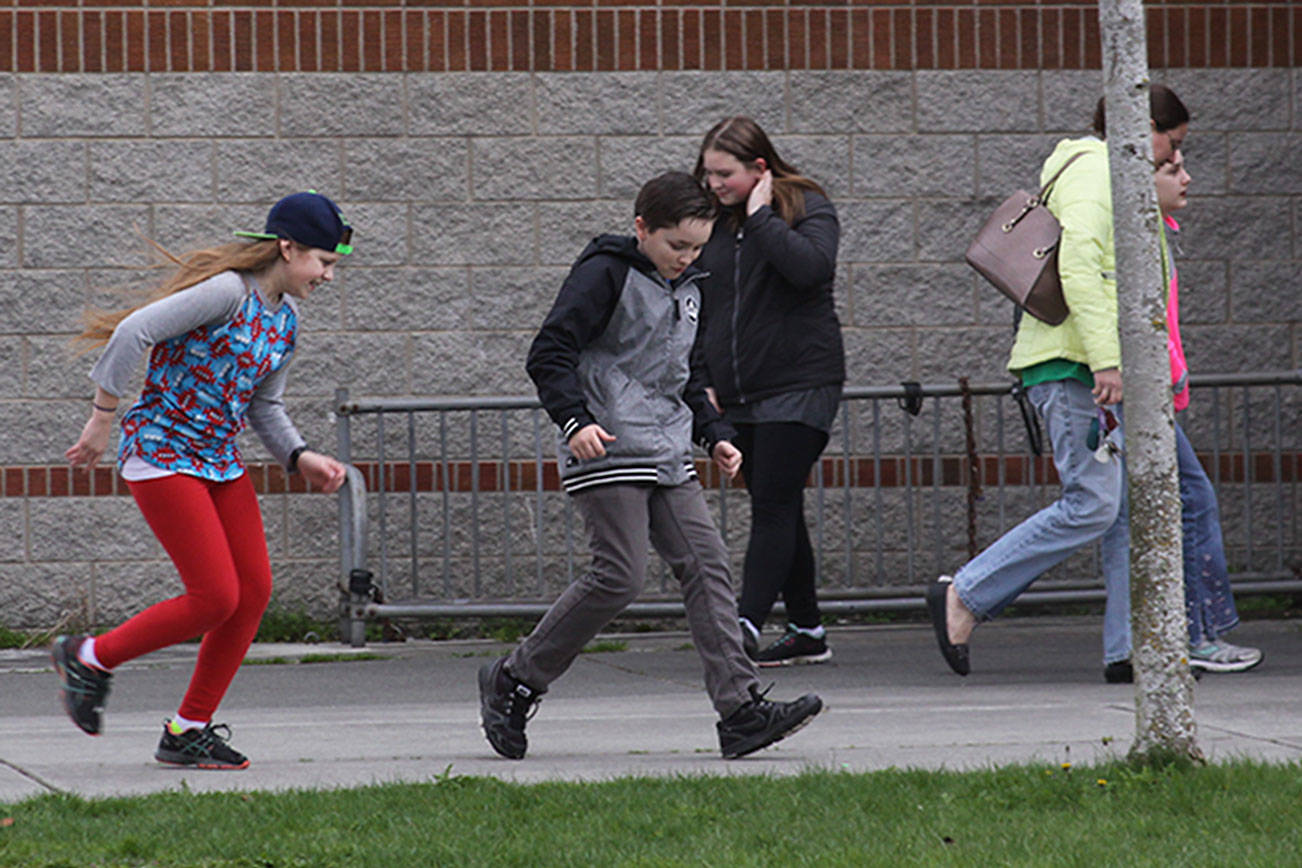 McKenna Somes, left, Jake Jarrell and Morgan Stevens enjoy a game after classes let out on the grounds of Coupeville Middle/High School Friday. The school district is reorganizing its leadership and making other changes to give the middle school its identity back and allow middle school students more time to be kids. Photo by Ron Newberry/Whidbey News-Times