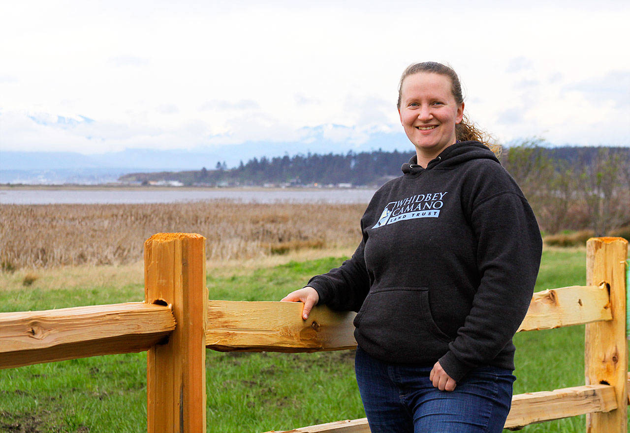 Jessica Larson, a land steward with the Whidbey Camano Land Trust, stands before a split-rail fence Thursday, Aprl 6, 2018 that was installed in March to keep duck hunters and others from parking on the property near Crockett Lake in Central Whidbey. The land trust purchased the 85-acre property from a private landowner in December on the lake’s northeast corner to protect it and its abundant species of birds as part of the 423-acre Crockett Lake Wetland Preserve. The newly acquired property had been a widely used access point and place to park for waterfowl hunters for years. Photo by Ron Newberry/Whidbey News-Times