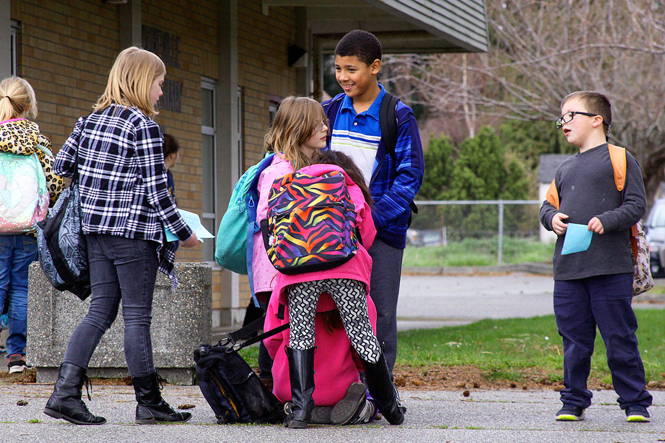 Coupeville Elementary School children wait to depart school grounds on March 31, 2017. The Coupeville School District is exploring options as it looks at long-range planning for the aging elementary school. One option is to build a new school away from the busy highway. Photo by Ron Newberry/Whidbey News-Times