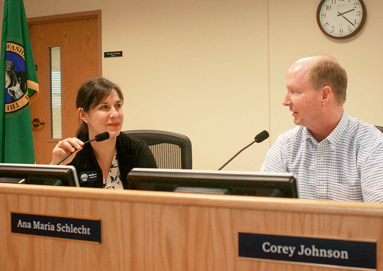 School board members Corey Johnson, left, and Ana Maria Schlecht converse in the district boardroom Thursday. Both have decided they will not seek reelection after their terms end later this year. Photo by Daniel Warn/Whidbey News-Times