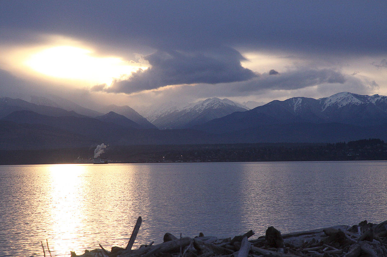 Looking over Admiralty Inlet on the west side of Whidbey Island on a gloomy January afternoon reveals a peek at the Olympic Mountains, the source of the area&rsquo;s rain shadow. Photo by Ron Newberry/Whidbey News-Times.