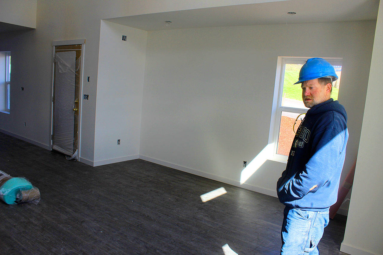Habitat for Humanity construction supervisor Skeeter Fagan, tours the first floor of a townhouse nearing completion in Oak Harbor near Skagit Valley College.