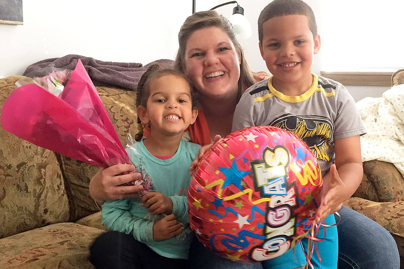 Melissa Brown and her two children celebrate moving into their Habitat for Humanity house on Dec. 28, 2015. Photo provided by Habitat for Humanity of Island County